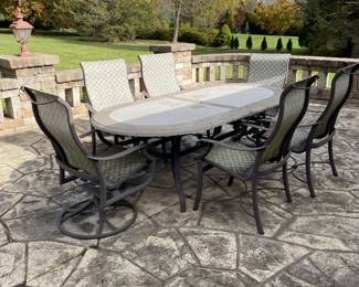 TROPITONE OVAL STONE TABLE WITH SIX CHAIRS 
TWO SWIVEL AND FOUR ROCKERS