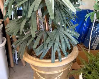 Faux plant in gold urn