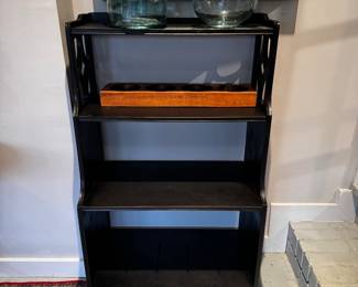 Bookshelf, small black painted with four shelves measures 26 inches wide by 43 inches tall by 15 inches deep.