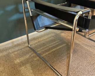 Wassily designer chair black leather straps and chrome accents. measures 30 inches wide by 27 inches tall by 27 inches deep.