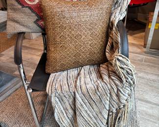 Black leather chair with 2 throw pillows and a shawl for sale