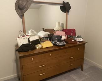 Vintage Drexel dresser with mirror.
Also shown: purses, including Coach.