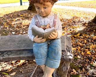 boy reading on bench