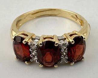 Signed three stone garnet and diamond, 14kt ring
