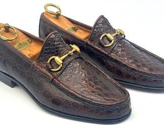 Never worn brown Gucci croc embossed leather loafers; men's size 6.5 D (fits Women's size 7.5-8 B); small tear on left shoe near heel (likely from a blade of some sort); includes wood shoe trees.