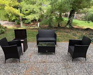 Outdoor wicker patio set with glass top table and storage cube.  