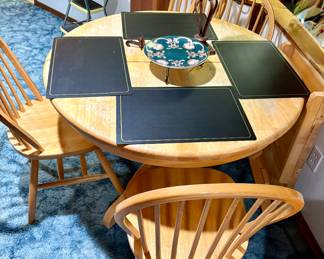 Great all wood table with leaf and four chairs .