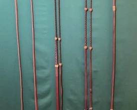 750  Three pair of leather reins and one leather over and under 
