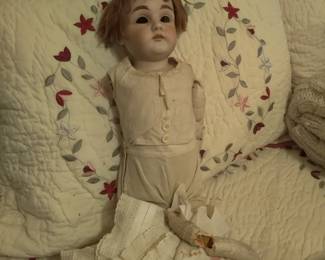 early 1900s porcelain doll. Arm detached and eyes need to be reset 