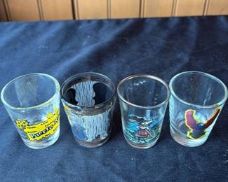 Set of four vintage shot glasses with tropical and wildlife designs 