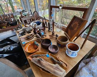 Sweet screened in porch with many natural items. Pine table with wooden items.