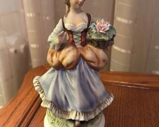 Porcelain Figurine of a Woman with Flowers