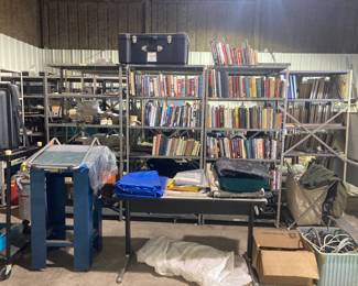 Drafting table, lots of books and shelving.