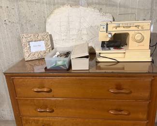 MCM dresser; Singer sewing machine; ship carving