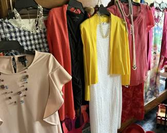 Many outfits hung together — complete with matching necklaces!