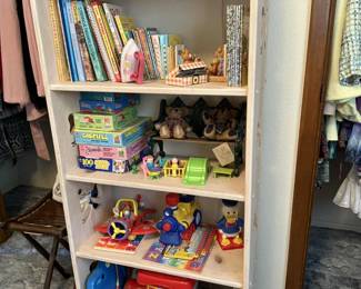 Bookcase & lots of toys! Look for Barbie dolls in the garage!