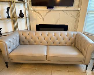 Gray leather tufted sofa