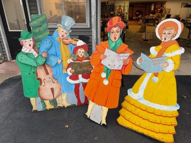 Vintage folk art Christmas carolers. Musicians have articulating arms.