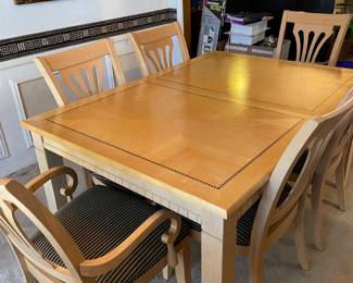 Table with leaf and 2 arm chairs and 4 side chairs.