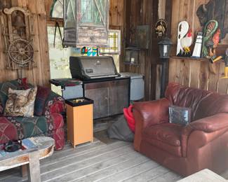 Weber grill and leather chair. Large lantern and wall art