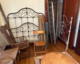 Cast metal bed, white is twin size and has the springs. Brown metal bed is a full size. Oak rocker with pressed board seat. Folding chair, maple.
