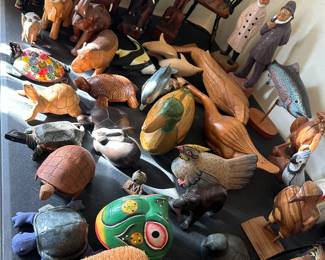 Close up of figural items on the table with the miniature chair.