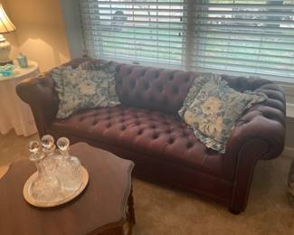 Very nice tufted sofa, it is not leather, but it looks very close to it