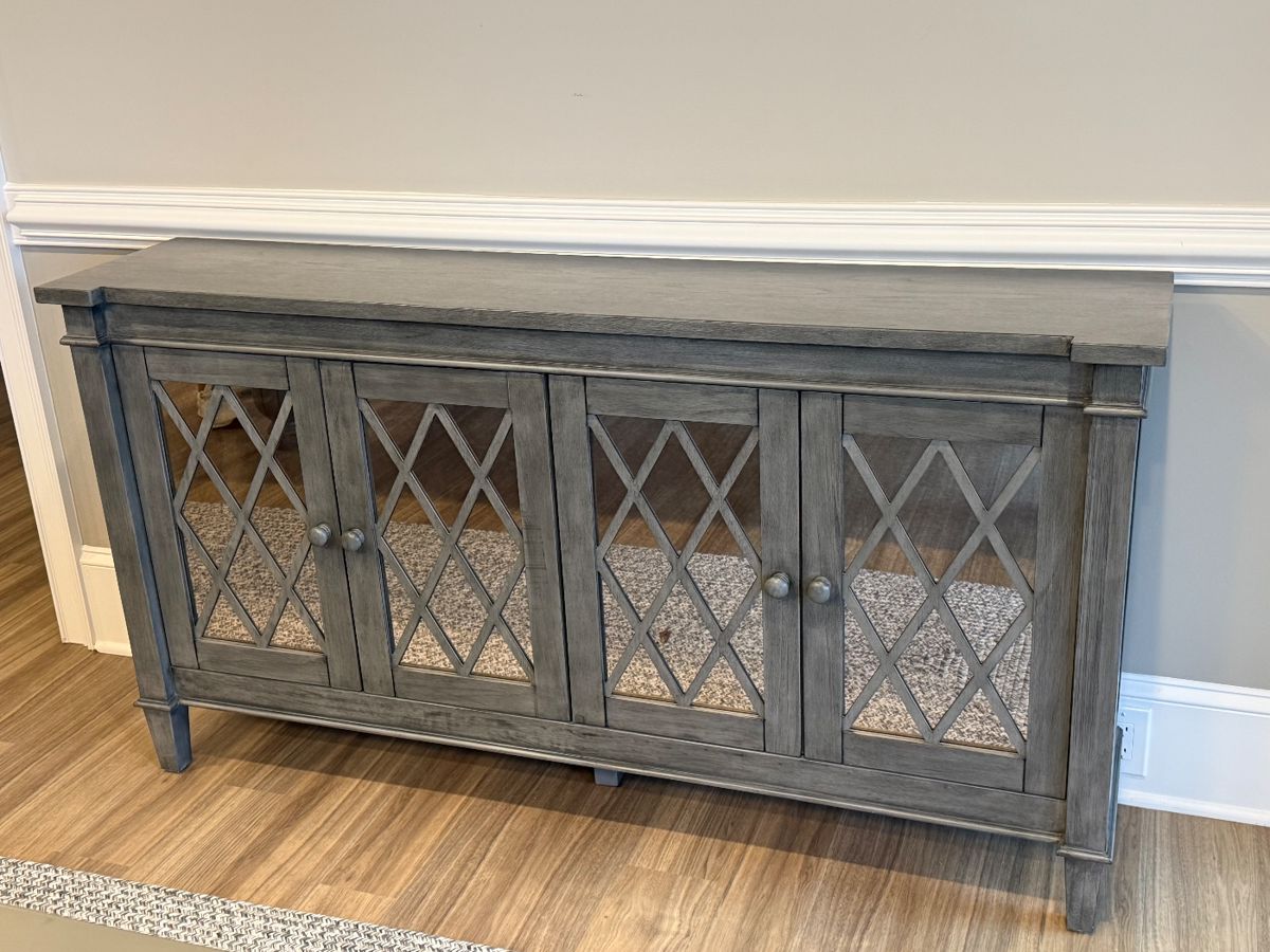 Item #2 - Gray Mirrored sideboard from Coast to Coast Imports.  Mirrored cabinet doors.  See next picture for condition of corner. L-64"  D-14"  H-34 1/4.                    Price - $160.00. Discounted Price -$ 80.00