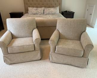 Item #37.  Pair of swivel glider accent chairs in a chenille fabric from Ashley Furniture.  H - 35 1/2in.  W- 33 1/2in. Floor to top of seat cushion- 19 1/2in.  Small stain on arm. Shown in next picture. Price - $350.00