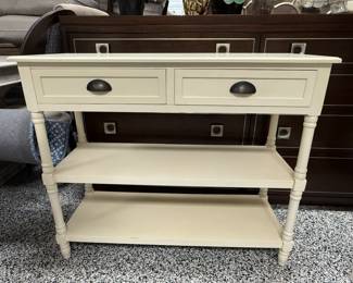 Item #47.  Cream 2 drawer 2 shelf console table.  From Home Goods. H- 32 1/4in. L- 38 1/2in. W- 15in. Good condition.  Price - $42.00