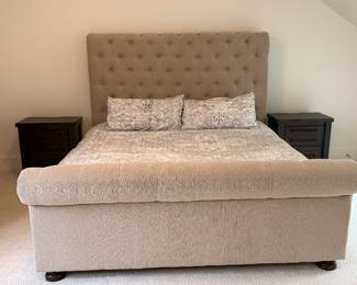 Item #36.  King/California King Tufted  sleigh bed from Ashley Furniture.  See next picture for small stain.    Headboard height- 67in.   Footboard height  -31in.       Price -$200.00.