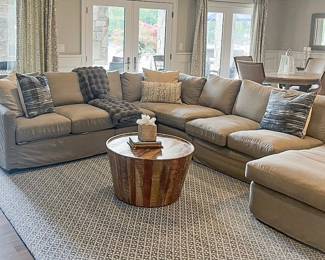 Item # 46.  Gray sectional by Simplicity Designs by Ally Whalen Interiors. Sectional is slipcovered.  Light stains on slipcovers. 6 pieces with locking mechanism.      Approximately 11x 8.      Price - $400.00