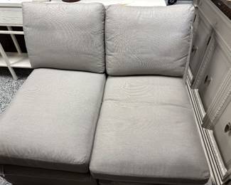 Item # 46.  Gray sectional by Simplicity Designs by Ally Whalen Interiors. Sectional is slipcovered.  Stains on slipcovers. 6 pieces with locking mechanism.  Approximately 11ft x 8ft.                    Price - $400.00.