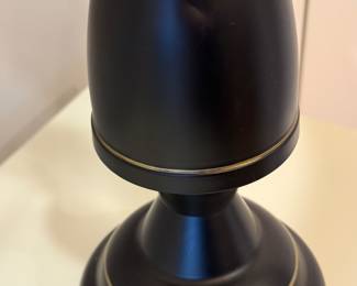Item # 12. Pair of rubbed bronze lamps.  Picture of  small dent on back of lamp.  H- 25 " to top of finial. Price - $20.