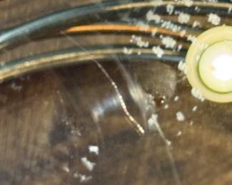 Item #22.  Gold and Silver accent table with glass top.  Small scratch on glass as seen in this picture.                       H- 22 1/2.  D- 22".  Price - $75.00.