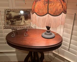 ANTIQUE OVAL WOOD SIDE TABLE, AND FRINGED VICTORIAN TABLE LAMP
