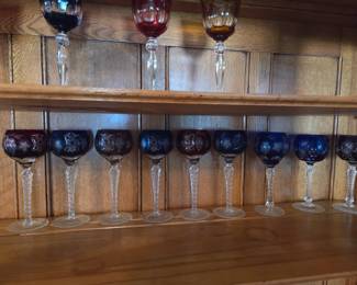 Hand carved Belgian Crystal wine glasses in Blue red and green and a few yellow