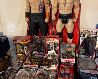 Vintage WWE Memorabilia including John Cena and Brock Lesnar dolls.