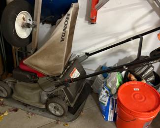 Honda Lawn mower, wheelbarrow and several ladders