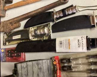 A machete and a variety of hunting knives