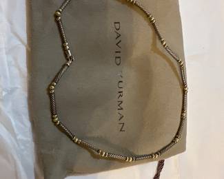 David Yurman
The item in the image is a David Yurman Hampton Cable Choker necklace. It is crafted from sterling silver and 14k gold, and the design features sections of the brand's signature twisted cable motif with round metal or pearl beads. This style is a part of the Hampton collection