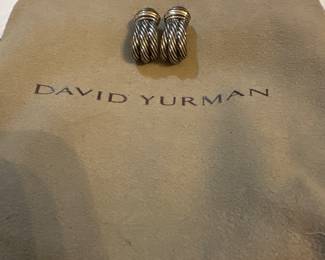 
David Yurman 
The product in the image is a pair of David Yurman Cable Hoop earrings. The earrings are characterized by the brand's signature twisted helix motif, which is a key feature of the Cable Collection. 