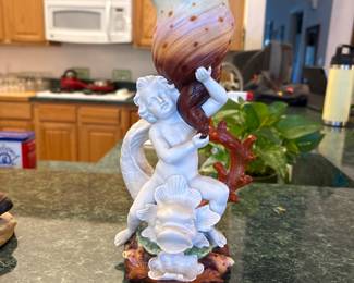 Capodimonte-Style Figural Cherub Vase
Beautiful hand-painted porcelain figural vase featuring a cherub riding a fantastical sea creature with coral and shell elements. Excellent detail and color with a striking vertical display presence. Perfect as a centerpiece or collector accent.
Price: $75