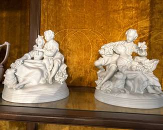 Bisque Porcelain Pastoral Figurine Pair
Lovely mid-century bisque porcelain figurines in the Rococo pastoral style, featuring young couples with grapes and dogs. Unpainted bisque finish with fine detail to folds, faces, and animals. Excellent cabinet display pieces. Sold as a pair.
Price: $75