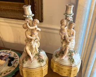 Vintage Porcelain Figural Candleholders (Pair)
Charming pair of vintage porcelain figural candleholders featuring classical maiden figures holding children, surrounded by applied floral details. Soft pastel tones with hand-painted accents and raised flowers on tiered octagonal bases. Beautiful decorative pieces with a romantic Victorian-inspired aesthetic.
These display wonderfully on mantels, sideboards, or vintage French/Italian décor settings. Sold as a matching pair.
Era: Mid-20th century (est.)
Material: Glazed porcelain
Details: Applied florals, pastel highlights, figural motif
Condition: Good vintage condition. Minor expected wear; small petals may show tiny chips typical for the style.                  Price: $ 175 (pair)                                                                                       First Day Sale: $125 (pair)