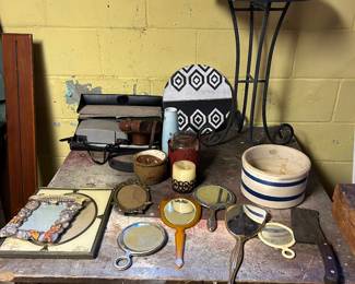 Mirrors, frames and candle vessels. Note the meat cleaver now teamed with the big butcher block.