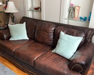 A nice leather sofa with nailhead trim.