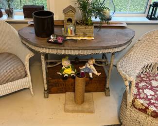 Wicker pieces highlighted by a Raggedy Ann  and Any-inspired ceramic pair.