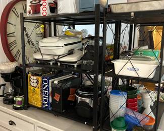 A big grouping of new in box and gently used kitchen goods. Notice the Fiesta toasted on the top shelf.