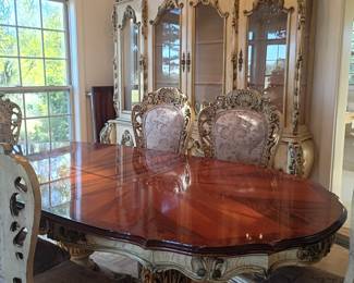 Venetian style dining room suite.
Double pedestal table is 87 inches long, with leaf extends to 105 inches long.
There are six dining chairs, the two end chairs have arms.
The china cabinet is 87 inches high at the highest point and is 52 inches wide.
The center cabinet features a built-in silver drawer.
This suite is very heavy and would have to be moved in a moving truck.
It's too heavy for a standard pickup truck or standard utility type trailer.